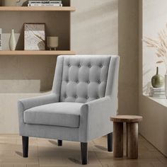 a gray chair sitting on top of a hard wood floor