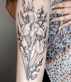 a woman's arm with flowers on it