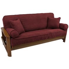 a futon couch with two pillows on it and a wooden frame around the arm