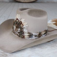 1 Unit Width: 3 cm Length: approx. 58cm (not including leather ties) One size fits most. Adjustable with leather ties. Hat not included. Center crest measures 5" W x 4.5" H. CA Residents: Prop 65 Warning ↗️ Luxury Brown Hat Bands For Festivals, Feathered Cowboy Hat Band, Luxury White Country Hat Bands, Feather Hat Band, Cowboy Hat Design, Custom Cowboy Hats, Cowboy Hat Bands, Beaded Hat Bands, Beaded Hat