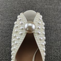 SPECIFICATIONS Indulge in a luxurious look with these pearl studded heels sandals! Crafted with comfortable PU upper material, these sandals feature an open toe style and solid pattern, with just the right heel height (3cm-5cm). You are sure to turn heads while your feet are cradled in total comfort with a rubber outsole, PU lining, and rubber insoles. Slip-on fit true to size for the perfect casual evening look! With Platforms: No Upper Material: PU Toe style: open toe heels Size: 34 35 36 37 3 White Pearl Open Toe Heels, Pearl Open Toe Wedding Shoes For Formal Occasions, Formal Open Toe Pearl Wedding Shoes, Formal Pearl Open Toe Wedding Shoes, Pearl Open Toe Heels For Evening, Elegant Pearl-embellished Open Toe Sandals, Pearl Round Toe Heels For Formal Occasions, Elegant Pearl Sandals For Party, Formal Pearl Heels With Round Toe