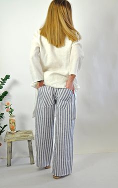 "Natural Linen White pants. Summer Loose Drop crotch Pants. Loose asymmetric linen pants. Every day comfortable pants. Maxi trousers. Cool casual pants. Striped 100% lINEN pants. Comfortable and Relaxed. Zipped pants. The style I used was originally designed and professionally constructed by me. Each item of my shop has a special package. Handmade in a pet-free and smoke- free environment. Model on picture is wearing size S Size chart Gabyga: XS (US 2, UK 6) Bust: around 33.5\" / 85 cm Waist: ar Baggy Linen Bottoms For Vacation, Beach Linen Harem Pants With Pockets, Beach Harem Pants With Pockets In Linen, Vacation Linen Harem Pants With Loosely Fitted Hips, Loosely Fitted Linen Harem Pants For Vacation, Linen Pants With Pockets, Flax Bottoms With Pockets For Beach, Linen Pants With Pockets For Beach, Linen Beach Pants With Pockets