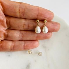 10K Solid Gold 6-7 mm white rice freshwater cultured pearl dangle post  earrings  SIZE:     Height: 15mm 10k gold post: 3.7mm  Drop: 10mm Closure: 10k Solid silicone push back THE SIZE OF THE PEARL MAY VARY REAL FRESHWATER PEARL Sold as a pair REAL 10K GOLD NOT( PLATED OR FILLED)....   10k Stamped for Authenticity  Nickel and Lead Free... Hypoallergenic.  FREE GIFT BOX Hypoallergenic Pearl White Teardrop Jewelry, Hypoallergenic Drop Pearl Earrings For Anniversary, Hypoallergenic Drop Pearl Earrings Dainty Style, Hypoallergenic Pearl White Pear Shaped Earrings, Dainty Drop Pearl Earrings Hypoallergenic, Hypoallergenic Teardrop Pearl Earrings For Anniversary, Hypoallergenic Teardrop Pearl Earrings For Anniversaries, Freshwater Pearl Earrings, Solid Gold Earrings