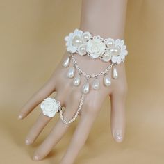 This an absolutely stunning bracelet very elegant and sophisticated. This bracelet is one size fits all with adjustable chains for the cuff area and an adjustable ring to fit all sizes. The cuff area is made with white lace and decorated with white pearls and a gorgeous white polymer clay rose and then to connect with the ring is a chain with tear drop pearls and to match the bracelet is the same white rose polymer clay. Please take a look at my shop I have other bracelet you might love! a large Delicate White Adjustable Jewelry, Elegant White Pearl Bracelet With Adjustable Chain, Adjustable Pearl Bracelet For Wedding, White Pearl Bracelet With Adjustable Chain, White Pearl Bracelet For Party, White Pearl Chain Bracelets For Party, White Pearl Bracelets With Adjustable Chain, Adjustable White Bracelets For Wedding, White Adjustable Pearl Bracelet