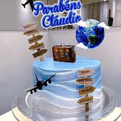 a cake with wooden signs and luggage on it that says paradise's clubio