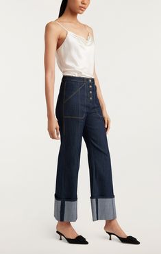 Make a modern statement in the Cuffed Benji Pants. Crafted from an elevated Denim Indigo fabric, these cropped trousers are perfect for any occasion with their utilitarian pockets and striking flared fit. Button fly and cuffs give this piece a modern feel, making you look chic and sophisticated. Details Button flyFabric: Indigo DenimHigh risePatch pocket detailCropped Content and Care 77% Cotton 21% Polyester 2% ElastaneDry Clean OnlyImported Measurements 29in inseamMeasurements from size 4 Dyes Indigo Fabric, Indigo Colour, Denim Chic, High Hips, Denim Patches, Cuffed Pants, Parisian Chic, Cropped Trousers, Cropped Denim