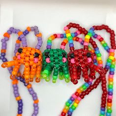 several colorful beads are arranged on a white surface