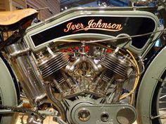 an old fashioned motorcycle is on display in a museum