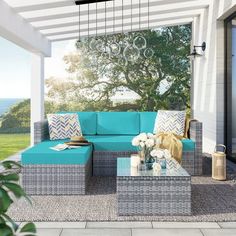 an outdoor living room with blue couches and coffee table