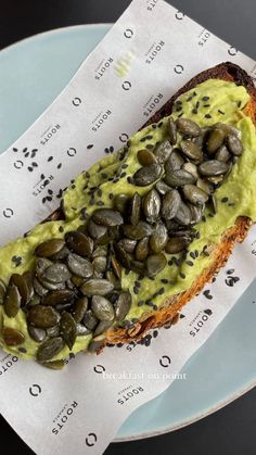 a piece of bread with seeds on it sitting on a plate