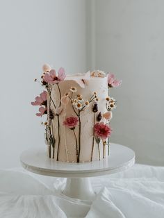 a white cake with pink flowers on it