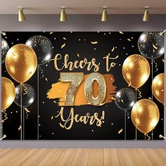 a room with balloons and confetti on the wall that says cheers to 50 years