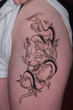 a woman's thigh with a tattoo design on it, and an image of a tiger