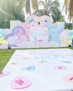 a large white table topped with balloons and confetti