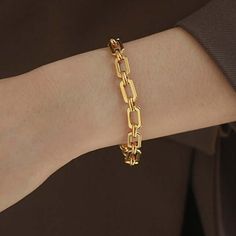 ✦ Make a statement with our bold 18K gold plated bracelet, crafted in a thick chain style for an eye-catching look. Designed to elevate your wrist with timeless elegance, this bracelet is perfect for adding a touch of sophistication to any outfit. With its bold design and luxurious gold plating, it's the ultimate accessory for making a chic and confident impression. ----------- DETAILS ----------- - Color: Gold - Size (Length x Width): 17.8cm x 0.7cm - Materials: Brass, 18K Gold Plated - SKU: QT Luxury Gold Oval Chain Jewelry, Luxury Chic Oval Link Bracelet, Luxury Oval Link Chain Bracelets, Modern Chunky Chain Link Bracelets, Modern Chunky Link Bracelets, Modern Chunky Link Bracelet, Gold Chunky Chain Link Bracelet, Modern Chunky Bracelets, Modern Chunky Bracelets For Everyday