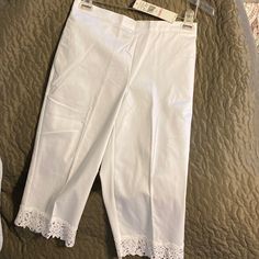 Alfred Dunner White Capris Size 6 Petite With Detailed Trim Of Lace Flowers. From Inseam To Bottom Of Lace 18 Inches. From Top Of Waist Band To Bottom Of Lace Trim 27 1/2 Inches White Knee-length Bottoms With Pockets, White Bermuda Pants For Summer, White Classic Cropped Leg Bottoms, Classic White Cropped Leg Bottoms, Classic White Cropped Bottoms, Fitted Capri-length Pants For Spring, Fitted Capri Length Pants For Spring, Elegant White Bermuda Bottoms, Spring Fitted Short Leg Pants