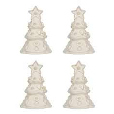 four white ceramic christmas trees with ornaments