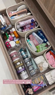 an organized drawer in a bathroom filled with personal care items