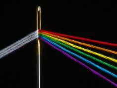 a rainbow - colored object is shown in the dark sky with long thin lines coming out of it