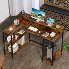 a wooden desk sitting on top of a hard wood floor next to a plant and bookshelf