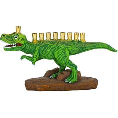 a green toy dinosaur with gold cups on its head