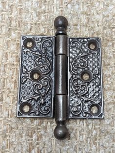 an antique style door hinge with decorative design