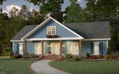 a blue house with white trim and two windows on the front porch is surrounded by green grass and trees