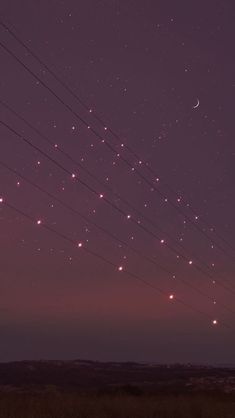 the night sky is filled with stars and power lines