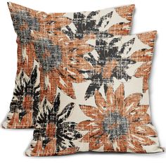 two pillows with orange and black flowers on them