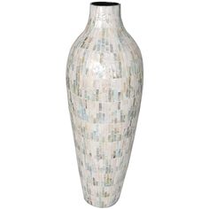 a white vase with blue and green mosaic tiles on the bottom is shown in front of a white background