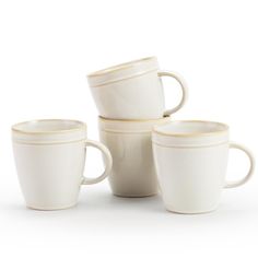 four white coffee cups stacked on top of each other