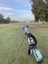 a golf bag sitting on top of a green field