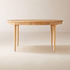 a wooden table sitting on top of a white floor