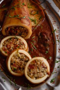 an enchilada with meat and vegetables on a plate