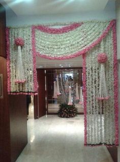 an entrance decorated with pink and white flowers