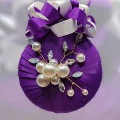 a purple ornament with pearls on it