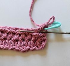 the crochet stitch is being worked on with scissors