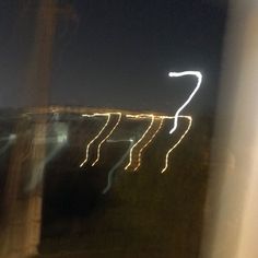 blurry photograph of street lights at night from outside the window with no one in it