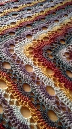 a multicolored crocheted blanket with circles on it