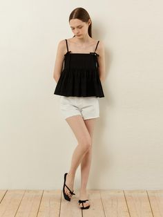 This is a feminine and trendy top by LADYVOLUME that is made out of high quality and sturdy material. With distinctive mood of the design and comfortable wear, you can style it for your casual daily outfit.- Slim shoulder string and sleeveless design- Embossed jacquard fabric- A line frilled silhouette- Trendy and feminine mood Black Relaxed Fit Tank Top For Spring, Black Cami Top For Spring, Black Cotton Summer Top, Feminine Black Sleeveless Top, Casual Spring Cami Blouse, Chic Black Relaxed Fit Tank Top, Black Feminine Cotton Tops, Feminine Black Cotton Top, Casual Cotton Cami Blouse