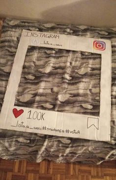 an instagram photo frame made out of fabric on the floor in front of a wall