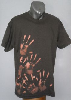 a black t - shirt with red and white fireworks on it is sitting on a mannequin