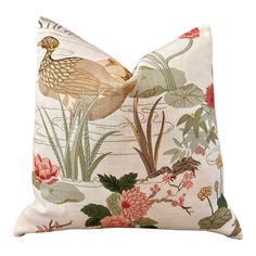 a white pillow with a bird and flowers on the front, along with water lilies