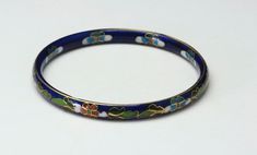 "-Vintage Cloisonné bangle bracelet pair, one has a dark blue base the other has a black base -Cloisonné patterns are on both out outside and inside of each bangle -No makers marks -Great vintage condition: the blue base has minimal markings to the enamel; the black base has a few markings to the enamel on close inspection -Bangle size: 8\", each -Width: black-a hair under 1/4\"; blue-a hair over 1/4\" -Depth: 3/16\", each -Weight: black-18.3g; blue-19.5g -Add this pair of beautiful vintage dark Blue Enamel Bangle Perfect As A Gift, Blue Enamel Bangle As A Gift, Handmade Blue Enamel Bracelets, Blue Enamel Bangle Gift, Formal Black Enamel Bangle, Blue Enamel Bangle Bracelets, Blue Enamel Bangle Bracelet, Blue Enamel Bangle, Elegant Black Enamel Bangle