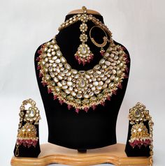 Adorn yourself in the timeless allure of our Beautiful Maroon Kundan Stones Bridal Necklace Set, reminiscent of the opulence seen in Jodha Akbar. This exquisite set, perfect for Indian and Pakistani weddings, features intricate Kundan stones that exude regal charm. The rich maroon hue adds a touch of elegance, while the set includes Sheeshpatti and Jhumka for a complete and stunning look. Embrace the grandeur of this bridal necklace set, where each piece captures the essence of cultural richness and the splendor of traditional craftsmanship, making it a captivating statement for your special day. ❋❋ This set includes - 1 Necklace, 1 pair of Jhumka Earring, 1 piece nosering, 1 Maang Tikka with Sheesh Patti ❋❋ ❋❋ Shipping Methods ❋❋ Standard Delivery - Take up to 8-14 business days (Worldwid Bollywood Lehenga For Marriage During Diwali, Bollywood Style Traditional Wear With Cutdana For Marriage, Ceremonial Kundan Bridal Sets With Zari Work, Heavy Kundan Dupatta For Diwali, Traditional Zari Work Choli For Marriage, Traditional Marriage Choli With Zari Work, Festive Marriage Sets With Zari Work, Semi-stitched Lehenga With Zari Work For Marriage, Traditional Choli With Pallu For Marriage