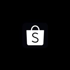 a black and white bag with the letter s on it's front side, against a dark background