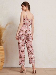 The pink base makes up any mood for an outing. The Floral Print Cami Jumpsuit also comes with a matching belt that cinches at the waist to accentuate your curves and create a flattering silhouette. The bold and vibrant floral print adds a pop of color and makes this jumpsuit perfect for any occasion, whether it's a brunch date with friends or a day out exploring the city. Features: Pattern Type: Floral, All Over Print Details: Belted, Wrap Length: Capris Type: Cami Fit Type: Regular Fit Neckline Romper Casual, Stylish Maxi Dress, Comfy Jumpsuits, Cami Jumpsuit, Fitted Maxi Dress, Casual Rompers, Boho Patterns, Women's Casual, Flower Print