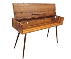 an old wooden desk with two legs and a drawer on the top that has holes in it