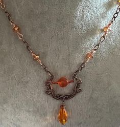 The rolo chain is bright copper and the TierraCast Poppy Festoon link is an antique copper and is 26x37mm.  The beads are a transparent light orange and the druks are wire wrapped to the chain.   The chain is 22" long and has a TierraCast hook and eye closure.  The matching earrings are a little over 1" long from the base of the ear wire to the bottom of the dangle. Vintage Orange Metal Necklaces, Vintage Orange Metal Necklace, Nickel-free Rust-colored Metal Jewelry, Vintage Orange Metal Jewelry, Orange Copper Wire Jewelry For Gifts, Orange Copper Wire Jewelry As A Gift, Orange Copper Wire Wrapped Jewelry, Orange Vintage Copper Jewelry, Soldered Copper Rose Gold Necklace