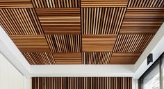 the ceiling is made out of wood and has vertical slatted panels on it